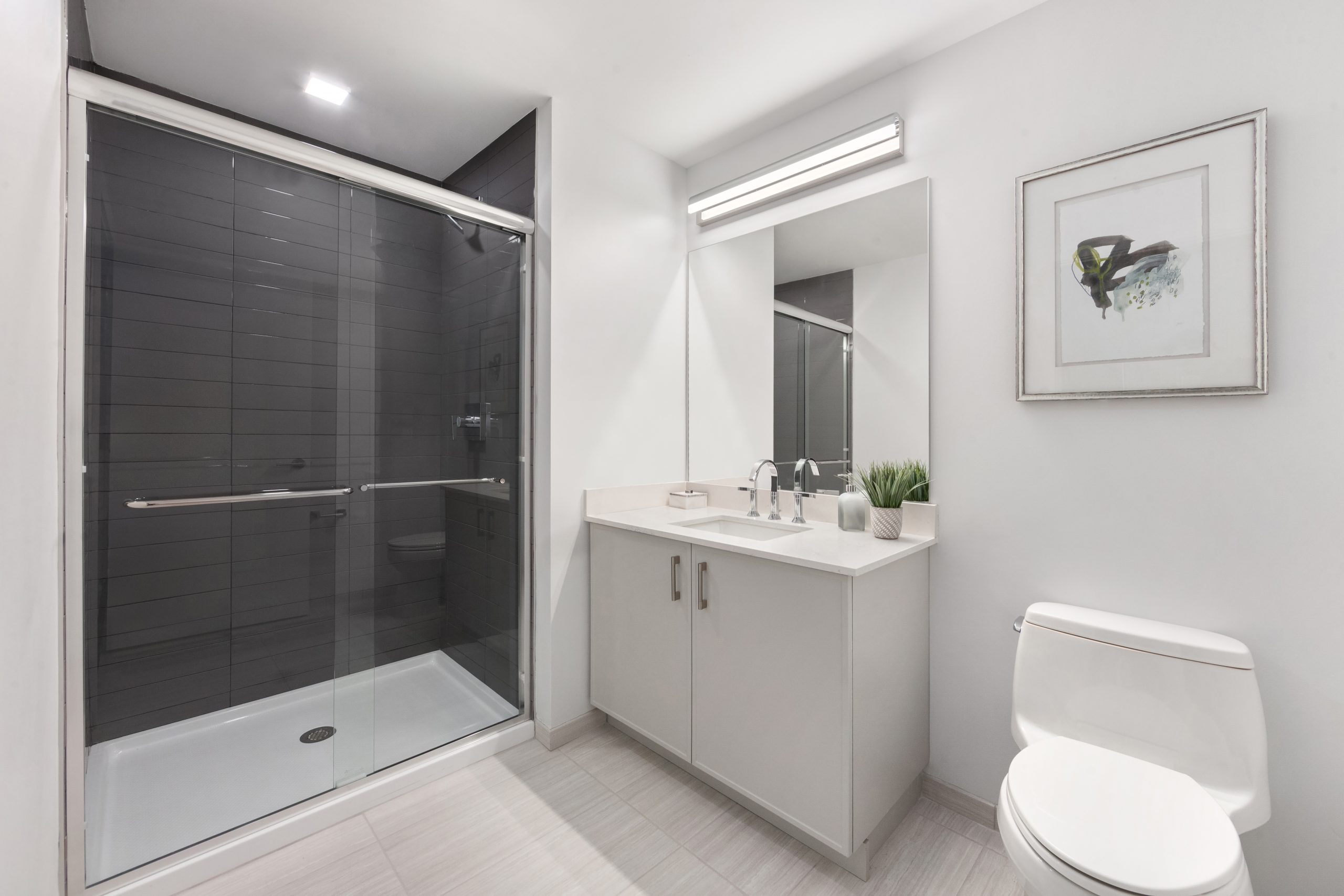 Porcelain-tiled baths and glass-enclosed showers bring a spa-inspired calm, blending sleek finishes with timeless design for everyday indulgence.